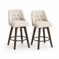 Set di 2 sgabelli in tessuto beige con struttura in legno e anello in metallo